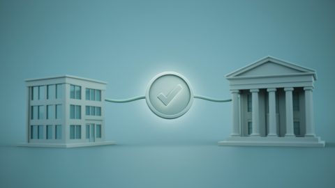 Conceptual illustration of a small office building icon linked to a bank building by a verification checkmark, evoking business address checks for banking
